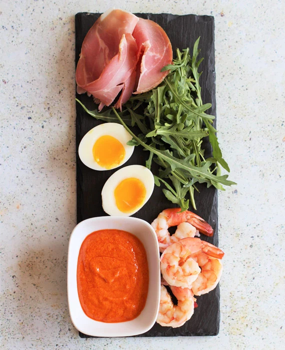 Spanish Tapas Plate of Egg, Prosciutto and Shrimp with Romesco and Arugula